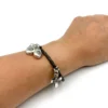 pulsera con cruz floreada y medallas
